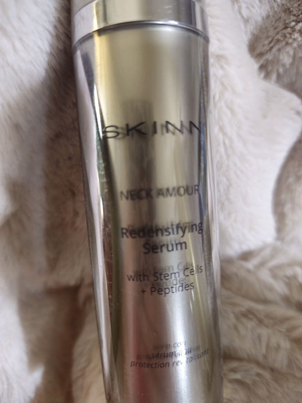 SKINN Neck Armour Redensifying Serum - Silver Metallic Bottle.
